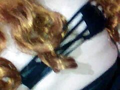 Masked mouth covered with black dildo thrust