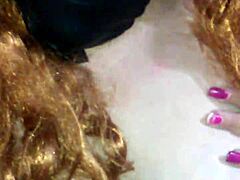Masked mouth covered with black dildo thrust