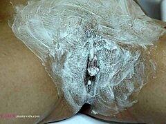 close-up hairy pussy gets an intimate shave with detailed trimming
