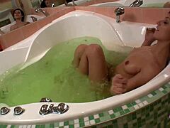 Steamy bath masturbation turns into lesbian dildo play and pussy licking.