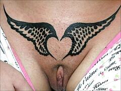 Crystal Butterfly flaunts intricate tattoo while rocking out to intense music vibes