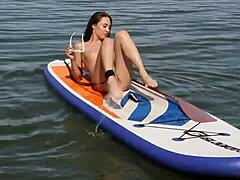 Petite brunette with shaved pussy walks naked on outdoor beach feeling exposed and free.