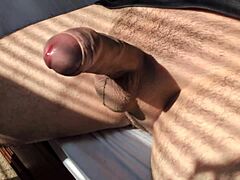 amateur guy strokes his big cock solo in bedroom close-up during hot summer