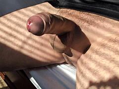 amateur guy strokes his big cock solo in bedroom close-up during hot summer