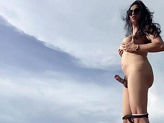 Asian ladyboy jerks off on white beach