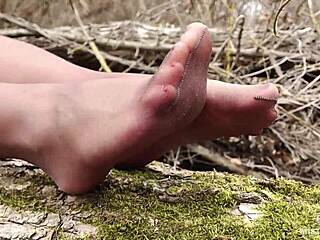 Close-up of a goddess in pantyhose teasing in nature