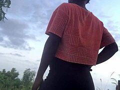 crazy woman twerking partially clothed in a dense forest setting