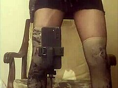 Crossdresser Maria struts in sheer black nylon pantyhose high heels miniskirt