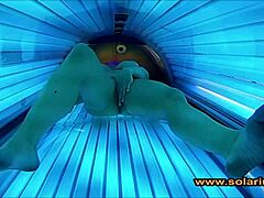 Beautiful solarium woman fingers pussy on cam