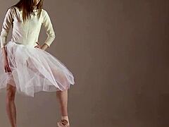 Blonde gymnast stretches flexibly during naked yoga workout in gym